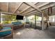 Comfortable screened porch with seating, a ceiling fan, and a view of the fenced backyard with playground at 3049 Condel Drive, Orlando, FL 32812