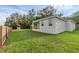 A large grassy backyard with an enclosed porch with wood railings at 31830 Sybil Ave, Sorrento, FL 32776