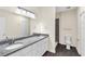 This bathroom has dual sinks, granite countertops, tile floors, and a tiled stand-up shower at 31830 Sybil Ave, Sorrento, FL 32776
