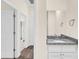 Hallway shot of bathroom vanity with granite countertop and tiled floors at 31830 Sybil Ave, Sorrento, FL 32776