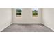 Cozy bedroom with neutral carpet and large windows offering plenty of natural light at 31830 Sybil Ave, Sorrento, FL 32776