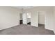 This bedroom features neutral walls and carpet, a large window, and a walk-in closet at 31830 Sybil Ave, Sorrento, FL 32776