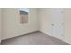 A carpeted bedroom with a window and a closet at 31830 Sybil Ave, Sorrento, FL 32776