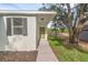 This single-story home has a covered front door area and a beautifully landscaped garden at 31830 Sybil Ave, Sorrento, FL 32776