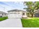 Charming single-story home with a two-car garage, fresh landscaping, and a well-manicured lawn at 31830 Sybil Ave, Sorrento, FL 32776