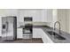 The kitchen features granite countertops, stainless steel appliances, and white shaker cabinets at 31830 Sybil Ave, Sorrento, FL 32776