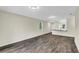 Spacious living area featuring modern lighting, wood-look floors, and an open layout to the kitchen at 31830 Sybil Ave, Sorrento, FL 32776