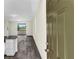 Bright and airy open floorplan with wood-look floors and sliding glass doors leading to the patio at 31830 Sybil Ave, Sorrento, FL 32776