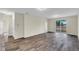 Bright and airy living space with wood-look flooring and sliding glass doors to the outdoor patio at 31830 Sybil Ave, Sorrento, FL 32776