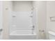 This bathroom boasts a modern shower-tub combination with bright white tile and sleek, chrome fixtures at 31836 Sybil Ave, Sorrento, FL 32776