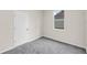 This bedroom has neutral walls, carpet flooring, a window with natural light, and a closet entry at 31836 Sybil Ave, Sorrento, FL 32776