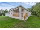 A back view of the house shows a small porch with wood railings and concrete steps at 31836 Sybil Ave, Sorrento, FL 32776