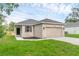 Charming single-story home featuring a two-car garage, well-maintained lawn, and neutral exterior paint at 31836 Sybil Ave, Sorrento, FL 32776