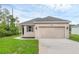 Charming single-story home featuring a two-car garage, well-maintained lawn, and neutral exterior paint at 31836 Sybil Ave, Sorrento, FL 32776