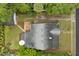 Aerial view of a home with a well-maintained roof, backyard deck, and mature trees surrounding the property at 40 W Smith St, Winter Garden, FL 34787
