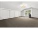 Spacious attic with carpet, white paneled walls, a window, and ample storage space with sliding closet doors at 40 W Smith St, Winter Garden, FL 34787