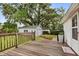 Backyard deck overlooking mature trees, a detached garage, and providing a serene outdoor living space at 40 W Smith St, Winter Garden, FL 34787