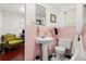 Classic pink and white bathroom featuring pedestal sink, toilet and a doorway showing an adjacent office space at 40 W Smith St, Winter Garden, FL 34787