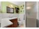 Bathroom with green walls and a walk-in shower in a home for sale at 40 W Smith St, Winter Garden, FL 34787