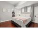 Bedroom with hardwood floors, white furniture, and walk-in closet in a home for sale at 40 W Smith St, Winter Garden, FL 34787