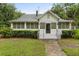 Close-up of front exterior with a cozy screened in porch and manicured hedges at 40 W Smith St, Winter Garden, FL 34787