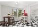 Cozy dining nook with a breakfast table, natural light, and the black-and-white checkered flooring at 40 W Smith St, Winter Garden, FL 34787