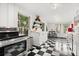 Cozy kitchen featuring stainless steel appliances, ample natural light, and black-and-white checkered floors at 40 W Smith St, Winter Garden, FL 34787