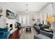 Cozy living room with a painted fireplace, wood floors, grey sofa, and stylish decor at 40 W Smith St, Winter Garden, FL 34787