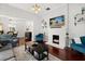 Bright living room featuring hardwood floors, a fireplace, stylish furniture, and an open layout at 40 W Smith St, Winter Garden, FL 34787