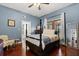 Bedroom with hardwood floors, ceiling fan, and four-poster bed in a home for sale at 40 W Smith St, Winter Garden, FL 34787