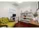 Bright home office with custom shelving, hardwood floors, a computer, and a comfortable vintage style chair at 40 W Smith St, Winter Garden, FL 34787