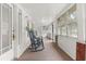 Inviting sun porch with rocking chairs, carpet floor, and an abundance of natural light through the windows at 40 W Smith St, Winter Garden, FL 34787