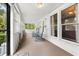 Relaxing sunroom with rocking chairs, large windows and carpeted floors offering a tranquil space to unwind at 40 W Smith St, Winter Garden, FL 34787