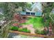 Aerial shot of the backyard with lush lawn, patio, and mature trees, showcasing the outdoor living space at 4201 Old Trafford Way, Orlando, FL 32810