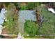 Aerial view of the property showcasing the roof, landscaping, and surrounding trees in a serene neighborhood at 4201 Old Trafford Way, Orlando, FL 32810