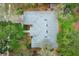 Birds-eye view of the home highlighting the roof, surrounding greenery, and proximity to neighboring properties at 4201 Old Trafford Way, Orlando, FL 32810