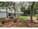 Picturesque backyard with ample green space, mature trees, and an inviting seating area, perfect for enjoying the outdoors at 4201 Old Trafford Way, Orlando, FL 32810