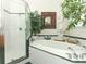 Bathroom featuring a tub, stand-up shower and many plants at 4201 Old Trafford Way, Orlando, FL 32810