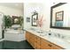 Bright Primary bathroom featuring double sinks, marble counters, and a soaking tub at 4201 Old Trafford Way, Orlando, FL 32810