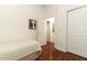 Bedroom with light walls, hardwood flooring, closet, and doorway at 4201 Old Trafford Way, Orlando, FL 32810