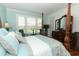 Cozy bedroom featuring a four-poster bed, natural light, and classic wood furniture at 4201 Old Trafford Way, Orlando, FL 32810