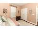 Cozy bedroom features a floral print comforter, a plush rug, and neutral wall paint at 4201 Old Trafford Way, Orlando, FL 32810