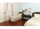 Bright bedroom with hardwood floors, two twin beds, and light blue walls at 4201 Old Trafford Way, Orlando, FL 32810