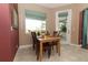 Cozy dining area with wood table set and screened patio in view at 4201 Old Trafford Way, Orlando, FL 32810