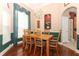 Inviting dining room with hardwood floors, a chandelier, and a window with elegant drapes at 4201 Old Trafford Way, Orlando, FL 32810