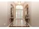 Bright foyer with tile flooring, decorative vases, and an arched transom window above the front door at 4201 Old Trafford Way, Orlando, FL 32810