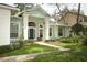 Inviting front exterior features a light blue facade, complemented by lush landscaping and walkway to the entrance at 4201 Old Trafford Way, Orlando, FL 32810