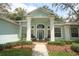 Inviting front porch featuring light blue siding, a tiled entryway, and two chairs ready for relaxation at 4201 Old Trafford Way, Orlando, FL 32810