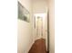 Hallway shows gleaming wood floors, white baseboards and door trim and is freshly painted at 4201 Old Trafford Way, Orlando, FL 32810