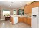 Bright eat-in kitchen with cabinets, tile floors, and view to the backyard at 4201 Old Trafford Way, Orlando, FL 32810